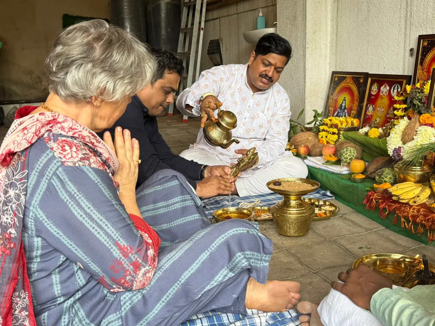 Dr Sukumar Sardeshmukh performing a traditional ceremony with guests at Atharva Ayurveda