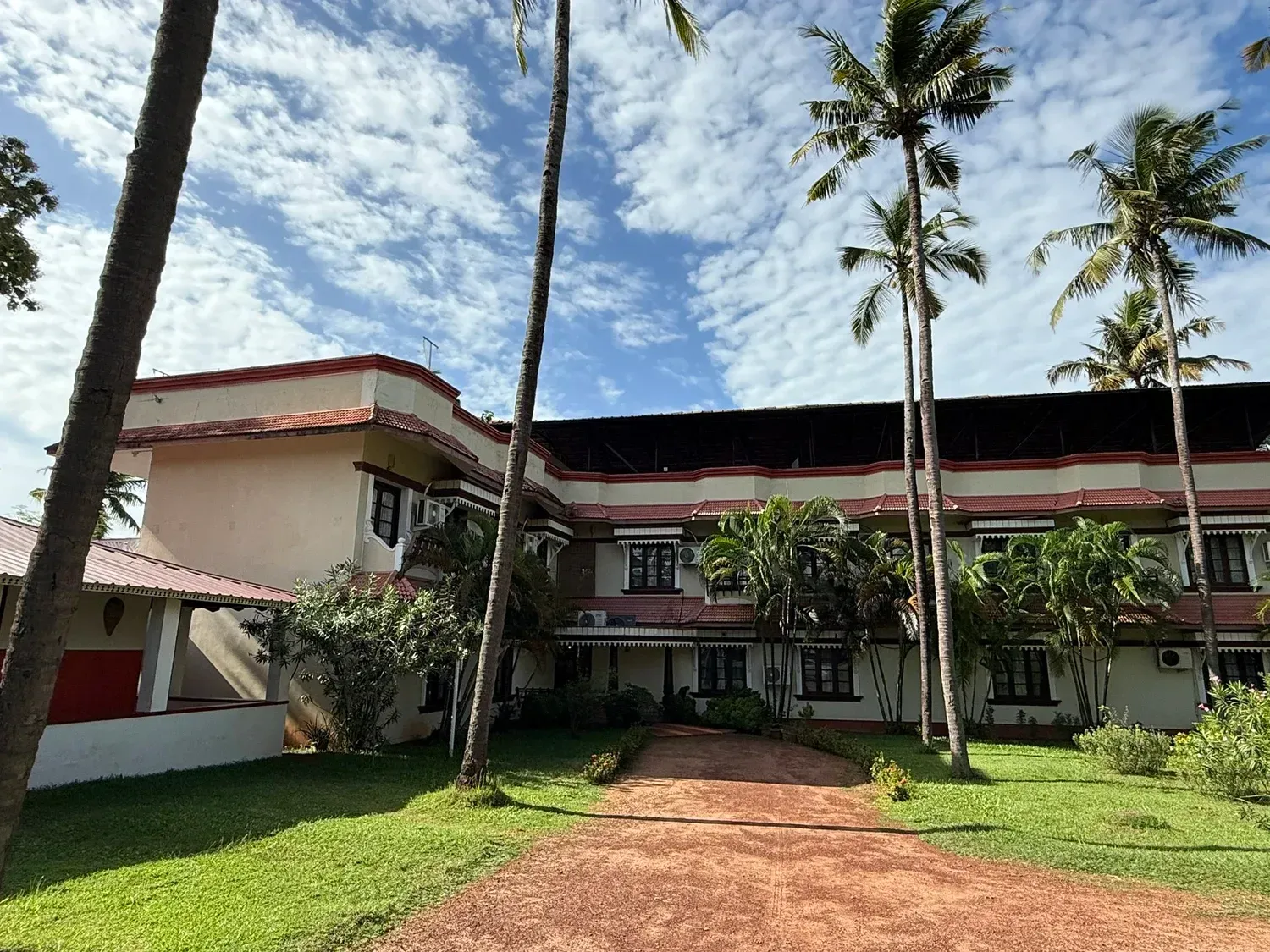 Coconut grove and lawns on the cliff top at Malika Ayurveda Beach Retreat