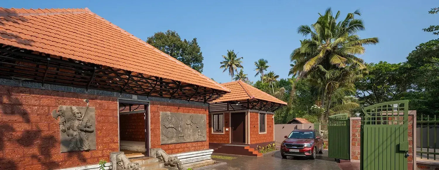 Laterite brick buildings with temple-style reliefs at Paradise Boutique Resort