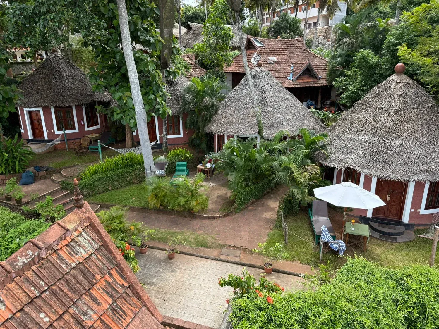 Round thatched cottages and gardens at Somatheeram Ayurveda Village